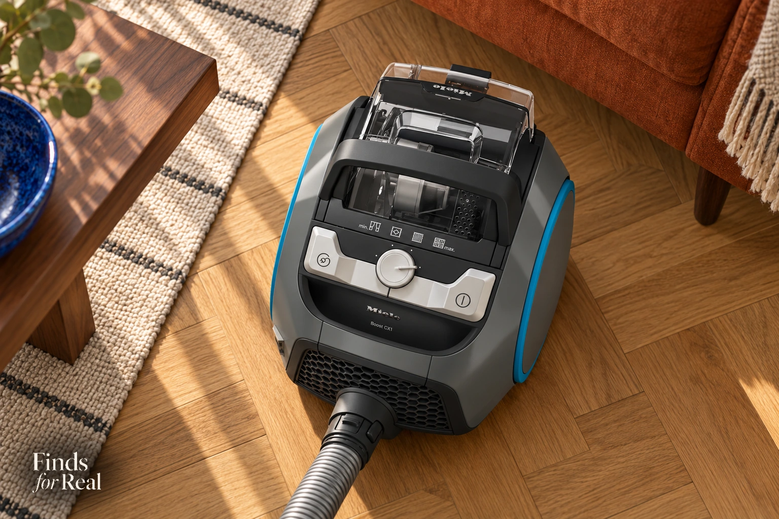Overhead detail of the Miele Boost CX1 suction dial, two pedals and clear dust container.